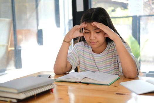 asian girl student studying hard feeling stressed tired exhausted bored. children education