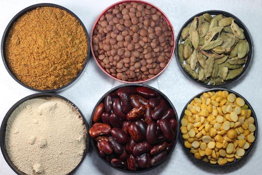 Top view of assortment of cereals, and cardamom. Collection of different spices and cereals.