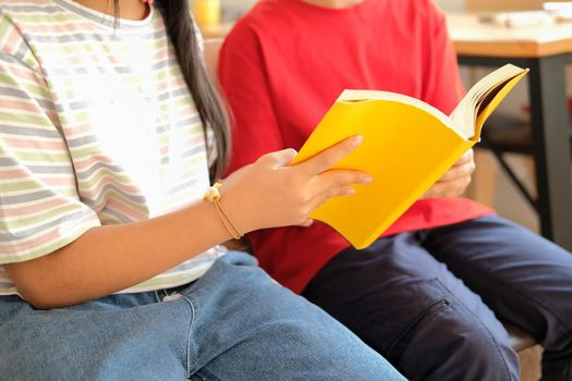 asian boy girl student studying reading book in library. learning education at school