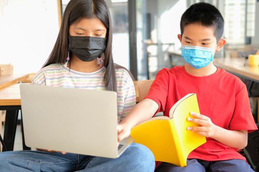 asian boy girl student wearing face mask studying learning lesson online. remote meeting distance education at home