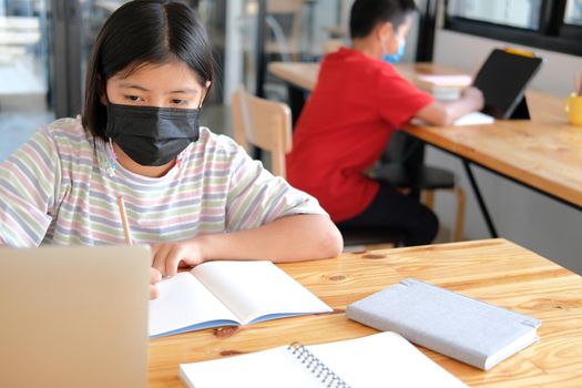 asian boy girl student wearing face mask studying learning lesson online. remote meeting distance education at home