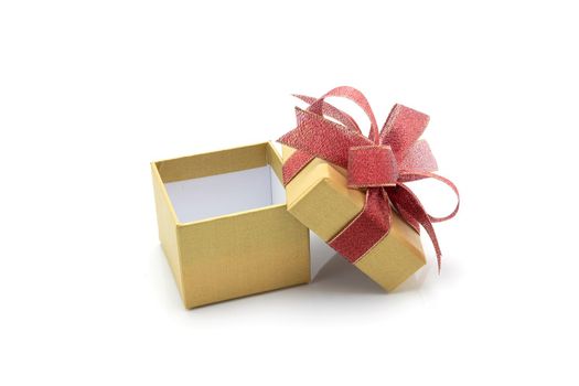 Gold gift box and ribbon open isolated on white background, presents in valentine day or Christmas day, object in birthday or anniversary, package with wrap luxury, holiday and festive concept.