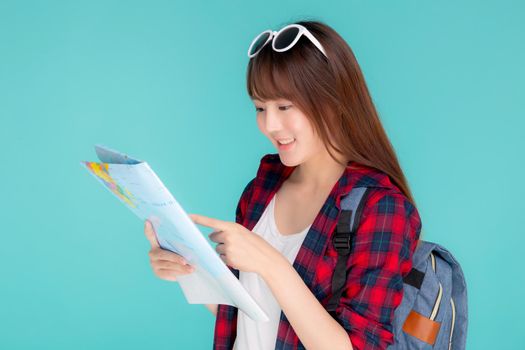 Beautiful happy young asian woman travel looking and pointing a paper map isolated on blue background, asia girl search journey with direction in vacation trip with cheerful for leisure.