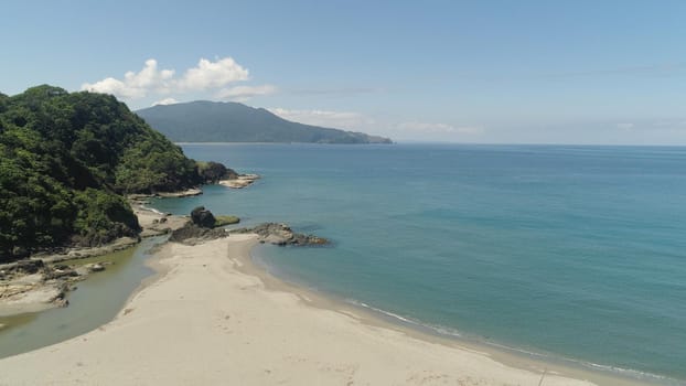 Aerial view of coastline with sandy beautiful beach. Philippines, Luzon. Ocean coastline with turquoise water. Philippines, Luzon. Tropical landscape in Asia.