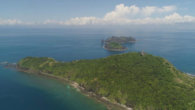 Aerial view of lighthouse in Palau island. Lighthouse in cape Engano against blue sky and rocky islands, province of Cagayan, Philippines.