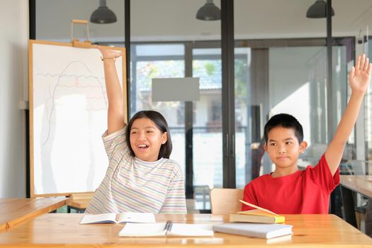 asian girl boy student studying raising hand in classroom. learning education at school