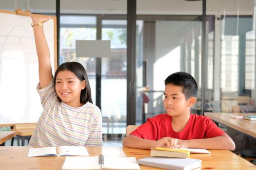 asian girl boy student studying raising hand in classroom. learning education at school