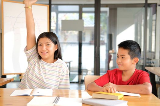 asian girl boy student studying raising hand in classroom. learning education at school