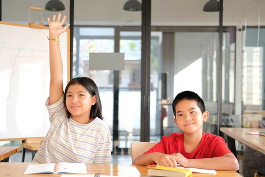 asian girl boy student studying raising hand in classroom. learning education at school