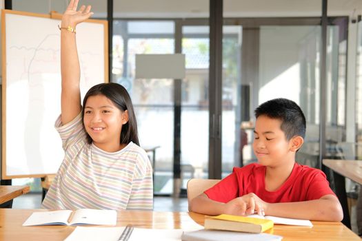 asian girl boy student studying raising hand in classroom. learning education at school