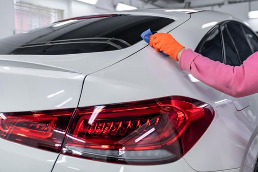 manual application of ceramic protection on the car body.