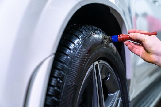 manual cleaning of car wheels with the help of brushing.