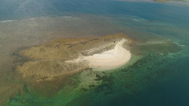 Tropical island with white sandy beach. Aerial view of sandy Crocodile island with colorful reef. Santa Ana Seascape, ocean and beautiful beach. Philippines. Travel concept.