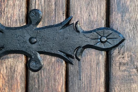 black metal decorative element on wooden doors