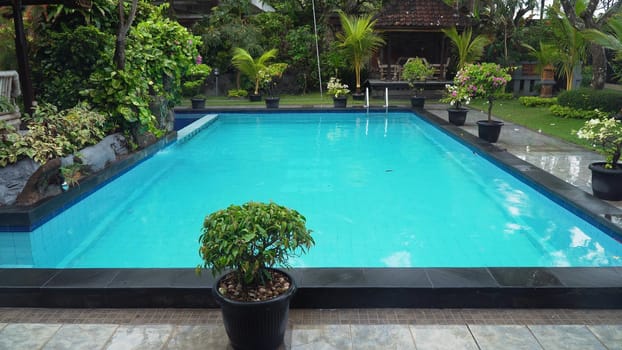 Luxurious open air swimming pool at resort. Swimming pool with turquoise water in a luxury hotel. Travel concept.