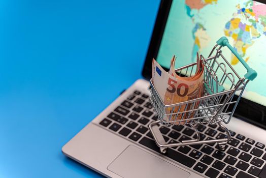 Shopping cart with euro banknotes. Online shopping concept.