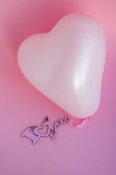 Pink balloon in the shape of a heart on a pink background, with a sign I love you. Wedding concept, Valentine's Day, photo zone, lovers. Banner. top view. Place for your text.