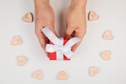 Gift box in men's hands for a holiday. View from above. Flat lay