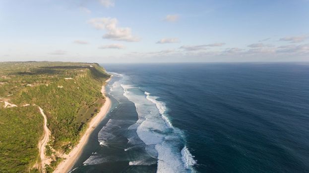 Aerial view of tropical beach with large wave. Large waves of turquoise water crushing on a beach Melasti, Bali,Indonesia. Travel concept.