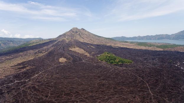 Aerial view of Mount Batur Volcano in Kintamani. Bali volcano, also referred to as Kintamani is popular sightseeing destination in Bali. Travel concept.