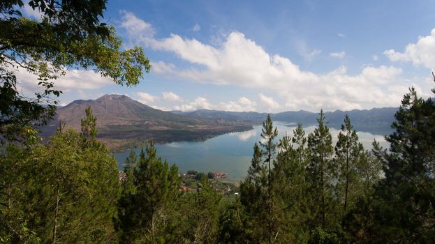 Aerial view Mountains, volcanoes, crater lake Batur, Bali, Indonesia. Mountain landscape with volcanoes, lake, sky and clouds. Travel concept