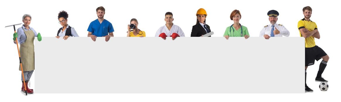 Group of diverse professionals holding blank banner ad isolated on white background