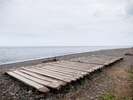 Production of sea salt in the Bali,Indonesia. Salt crystallizes out of the ground in salt farm, filled with natural salt from the sea.