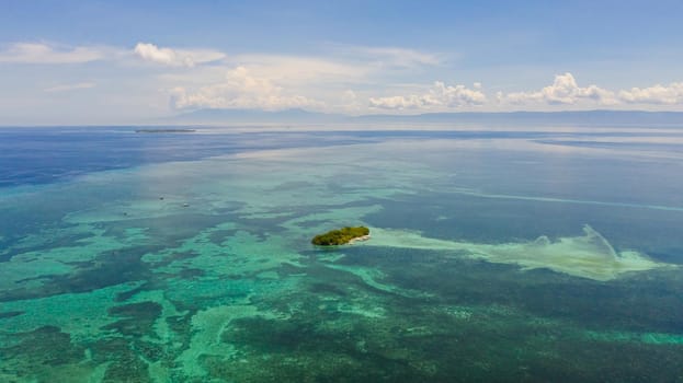 Tropical island in the blue sea by atoll with coral reef, top view. Panglao, Philippines. Summer and travel vacation concept.