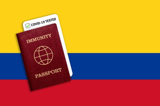 Concept of Immunity passport, certificate for traveling after pandemic for people who have had coronavirus or made vaccine and test result for COVID-19 on flag of Colombia