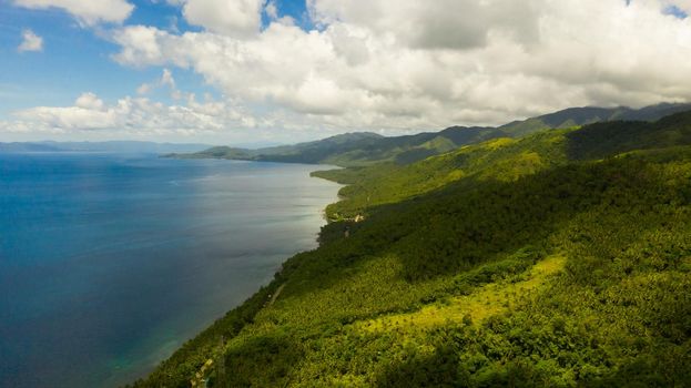 Tropical landscape: Leyte island with mountains covered with tropical green forest and blue sea. Seascape, Philippines.