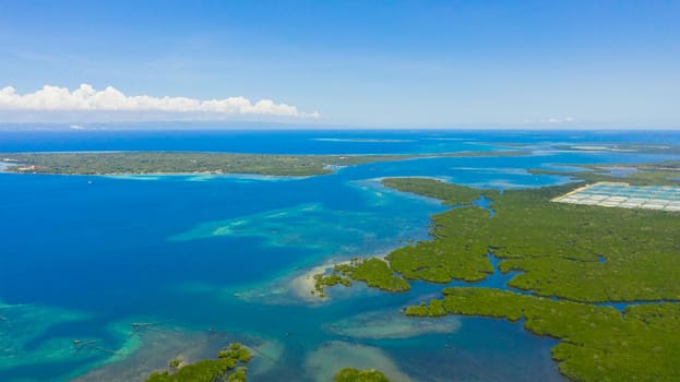 Aerial seascape: Tropical Islands and blue sea against the sky with clouds. The Strait Of Cebu,Philippines.