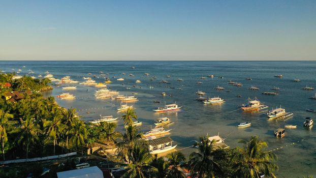 Traditional Filipino boats Boats on the beach during sunset. Panglao island, Bohol, Philippines. Summer and travel vacation concept.