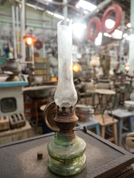 An old, vintage lamp with a shade in an antique store. Antiquarian shop with old ancient lamps. Antique street shop in Bali.