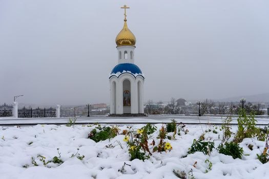 Petropavlovsk-Kamchatsky, Russia. the Church of St. Nicholas against a white snowy sky.
