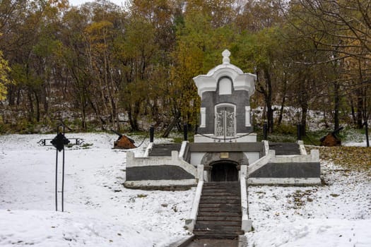 Petropavlovsk-Kamchatsky, Russia. Park with a white chapel on the background of autumn trees.