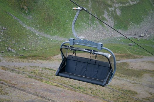 rope bench by cable car on a background of mountain landscape
