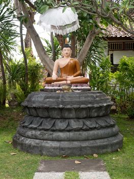 Statue of the Buddha god in the Buddhist temple Brahma Vihara Arama with statues of the gods on Bali island, Indonesia. Bali Architecture, Ancient design. Travel concept.