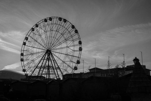 Ferris wheel on a monochrome sky background.