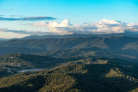 Natural landscape with mountain peaks under the blue sky.
