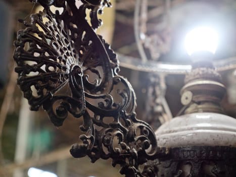 An old, vintage lamp with a shade in an antique store. Antiquarian shop with old ancient lamps. Antique street shop in Bali.