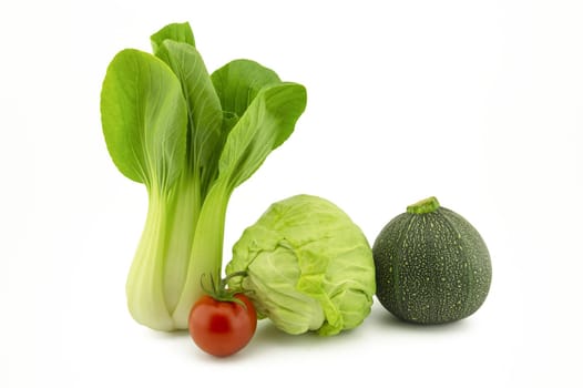 Chinese cabbage, green round courgette, white cabbage and cherry tomato isolated on white background