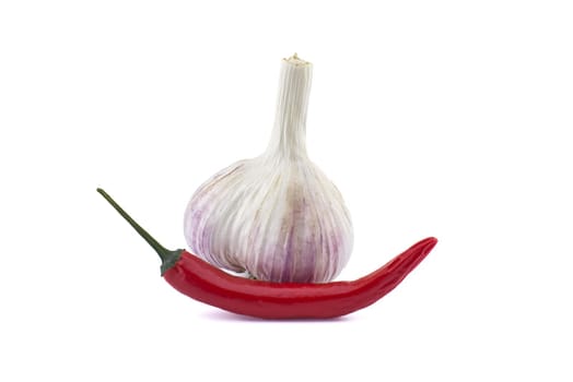 Garlic bulb and fresh small red chili pepper in close-up isolated on white background