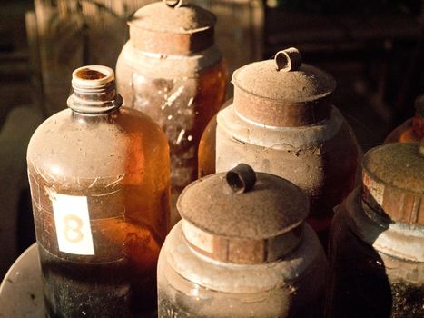 Antique street shop with old glass vessels, bottles, vintage items in Bali.