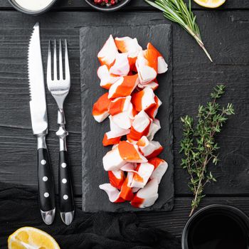 Fresh Crab meat surimi with blue swimming crab set, on black wooden table background, top view flat lay