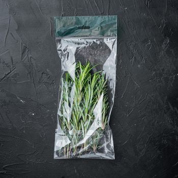 Fresh juicy Rosemary in market pack set, on black background, top view flat lay