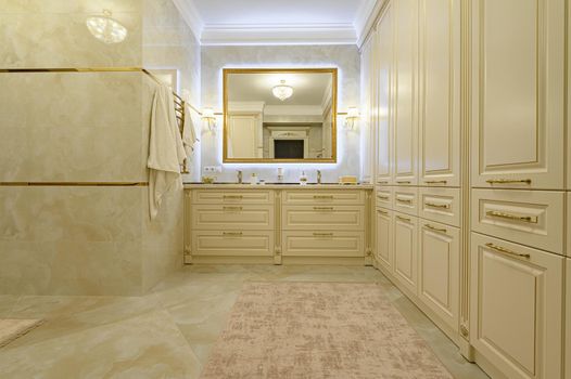 Modern luxury beige and golden bathroom with mirror, toilet, bidet and bathtub