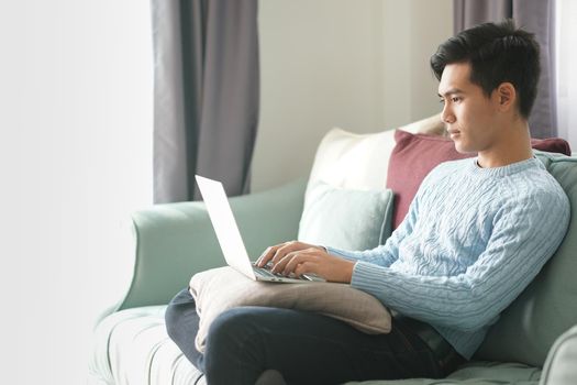 asian young teenage student man teenager entrepreneur working with computer studying learning online at home. e-learning webinar meeting. social distance in covid pandemic