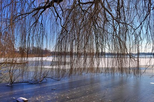 Snow covered frozen lake landscape in northern europe on a sunny day