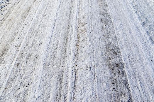 Tire Tracks on snow covered streets in a close up view