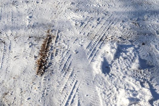 Tire Tracks on snow covered streets in a close up view